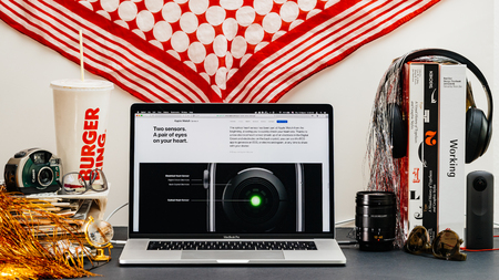 LONDON, UK - SEP 13, 2018: Creative room table with Safari Browser on MacBook Pro laptop showcasing Apple Computers website latest Apple Watch series 4 new two pair of senos on watchのeditorial素材