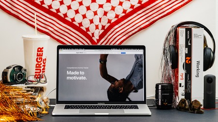 LONDON, UK - SEP 13, 2018: Creative room table with Safari Browser on MacBook Pro laptop showcasing Apple Computers website latest Apple Watch series 4 made to motivate advertorialのeditorial素材