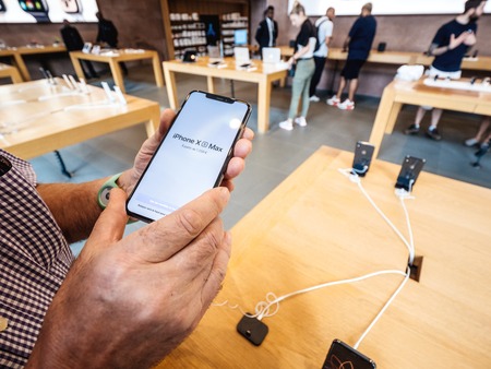 STRASBOURG, FRANCE - SEP 21, 2018: Apple Store with senior male customer people comparing admiring the new latest iPhone Xs Max along with Watch Series 4 wearableのeditorial素材