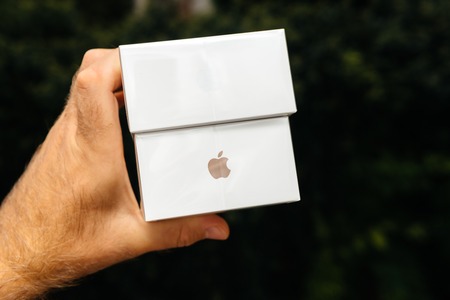 PARIS, FRANCE - SEP 21, 2018: Proud man customer POV comparing the new latest iPhone Xs and Xs Max smartphones telephones before the unboxing against green backgroundのeditorial素材