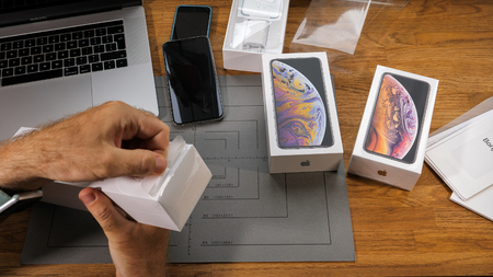 PARIS, FRANCE - SEPTEMBER 21, 2018: Apple fan boy unboxing latest new Apple Watch Series 4 GPS LTE Silver Aluminum Case with Seashell Sport Loop wearable smartwatch from Apple Computers removing plastic filmのeditorial素材