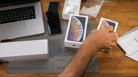 PARIS, FRANCE - SEPTEMBER 21, 2018: Apple fan boy unboxing latest new Apple Watch Series 4 GPS LTE Silver Aluminum Case with Seashell Sport Loop wearable smartwatch from Apple Computers choosing what to unbox firsのeditorial素材