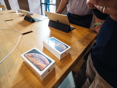 STRASBOURG, FRANCE - SEP 21, 2018: Apple Store with Genius seller-man hands near two iPhone Xs and Xs Max during the launch dayのeditorial素材