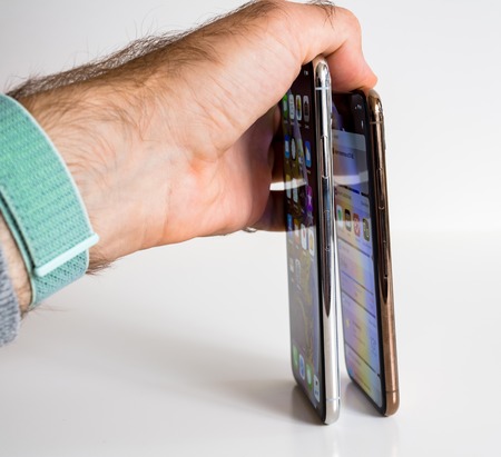 PARIS, FRANCE - SEP 25, 2018: New iPhone Xs and Xs Max smartphone model by Apple Computers close up. Newest golden Apple Iphone 11 mobile phone device on technology background square imageのeditorial素材