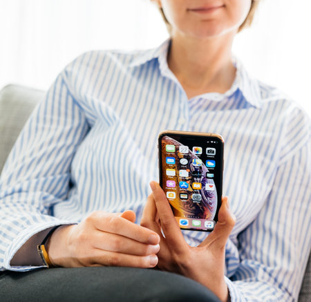 PARIS, FRANCE - SEP 27, 2018: Business woman testing the newest latest iPhone Xs and Xs Max...