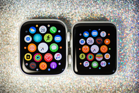 PARIS, FRANCE - SEP 28, 2018: Side by side Apple Watch Series 3 and Apple Watch series 4 wearable smartwatch computers by Apple Computers against sparling holiday backgroundのeditorial素材