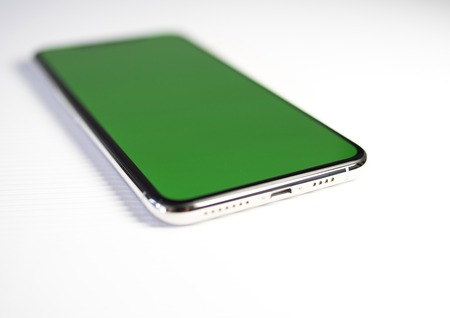 PARIS, FRANCE - SEP 27, 2018: Close-up shot of new Apple Computers iPhone Xs Max as hero object on white background - smartphone telephone with OLED display with green chroma key screenのeditorial素材