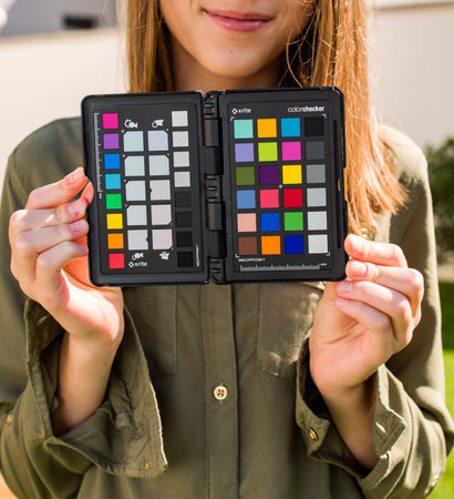 PARIS, FRANCE - SEP 30, 2018: Professional model holding Color Passport by X-Rite Color Reference Targets and camera calibration sfotware before the professional photo session shootingのeditorial素材