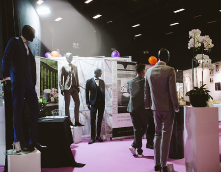PARIS, FRANCE - OCT 6, 2018: Wedding Exhibition Paris 2018 with seller booth with male costumes on...