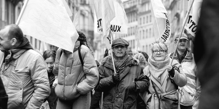 STRASBOURG, FRANCE - MAR 22, 2018: CGT General Confederation of Labour workers with placard at demonstration protest against Macron French government string of reforms - seniors in front of first row of protestersのeditorial素材