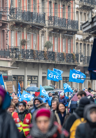 STRASBOURG, FRANCE - MAR 22, 2018: CGT General Confederation of Labour workers with placard at demonstration protest against Macron French government string of reforms - large crowd on street perturbing public transportationのeditorial素材