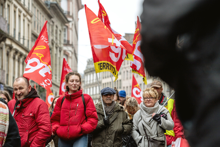 STRASBOURG, FRANCE - MAR 22, 2018: CGT General Confederation of Labour workers with placard at demonstration protest against Macron French government string of reforms - seniors in front of first row of protestersのeditorial素材