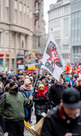 STRASBOURG, FRANCE - MAR 22, 2018: CGT General Confederation of Labour workers with placard at demonstration protest against Macron French government string of reforms - man with covered face with flags STRASBOURG, FRANCE - MAR 22, 2018: CGT General Confederation of Labour workers with placard at demonstration protest against Macron French government string of reforms - man with covered face with flags