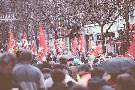 STRASBOURG, FRANCE - MAR 22, 2018: Rear view of crowd of protesters at CGT General Confederation of Labour workers with placard at demonstration protest against Macron French government string of reformsのeditorial素材