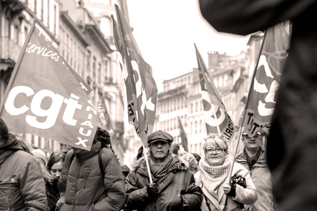 STRASBOURG, FRANCE - MAR 22, 2018: CGT General Confederation of Labour workers with placard at demonstration protest against Macron French government string of reforms - seniors in front of first row of protestersのeditorial素材