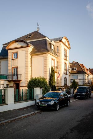 STRASBOURG, FRANCE - DEC 19, 2018: Beautiful building with Volkswagen car limousine and van parked on the streetのeditorial素材
