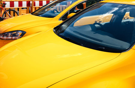 KEHL, GERMANY - SEP 1, 2017: Detail of two new yellow Volkswagen Golf cars parked near construction...