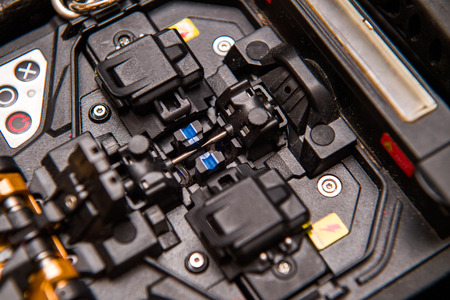 Macro detail of new modern innovative and powerful performance active clad-alignment splicer used for splicing an array of thin optical fiber typesの写真素材