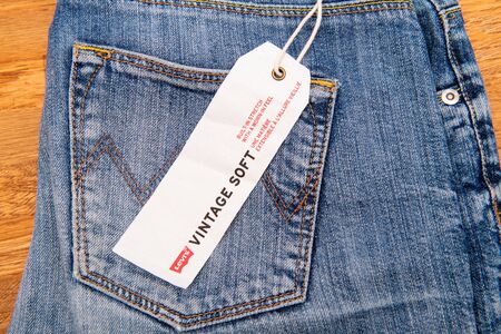 PARIS, FRANCE - JAN 2, 2018: New Jeans with price tag manufactured by the Levis placed on natural wooden table - model Vintage Softのeditorial素材