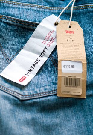PARIS, FRANCE - JAN 2, 2018: New Jeans with price tag manufactured by the Levis placed on natural wooden table - model Vintage Softのeditorial素材