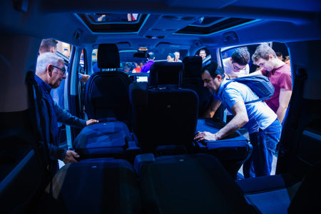 PARIS, FRANCE - OCT 4, 2018: Customers curious people admiring the interior and seat configuration of new Citroen Berlingo utility van at International car exhibition Mondial Paris Motor Show blue color castのeditorial素材