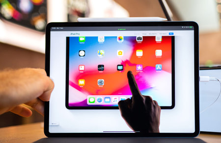 PARIS, FRANCE - NOV 7, 2018: Customer POV personal perspective experiencing new Apple iPad Pro with...