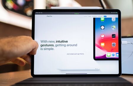 PARIS, FRANCE - NOV 7, 2018: Customer POV personal perspective experiencing new Apple iPad Pro with Face ID, A12X Bionic with Neural Engine and thin redesigned body - front view at intuitive gesturesのeditorial素材