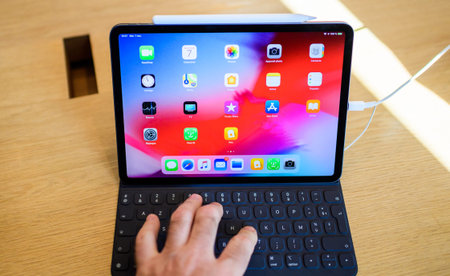 PARIS, FRANCE - NOV 7, 2018: Customer POV personal perspective experiencing new Apple iPad Pro with...