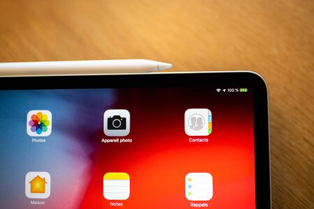 PARIS, FRANCE - NOV 7, 2018: Customer POV personal perspective experiencing new Apple iPad Pro tablet with Apple Pencil charging on the sideのeditorial素材