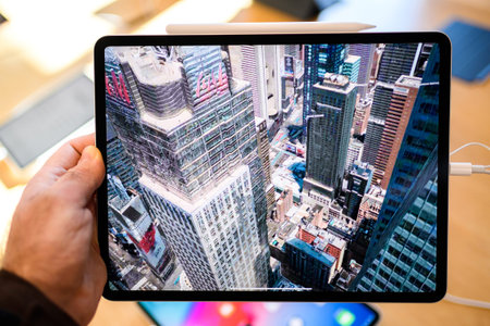PARIS, FRANCE - NOV 7, 2018: Customer POV personal perspective experiencing new Apple iPad Pro...