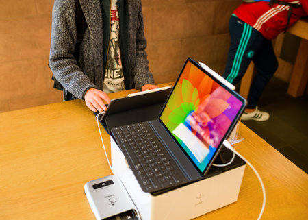 PARIS, FRANCE - NOV 7, 2018: Young customer POV personal perspective experiencing new Apple iPad Pro tablet with Face ID, Neural Engine and thin completely redesigned bodyのeditorial素材