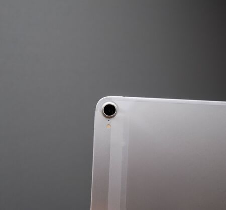 PARIS, FRANCE - NOV 14, 2018: unboxing unpacking the new iPad Pro by Apple Computers tablet against gray background - rear camera view of tablet in plastic filmのeditorial素材