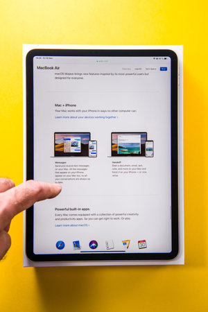PARIS, FRANCE - NOV 14, 2018: Man hand holding unboxing unpacking of new iPad Pro by Apple Computers...