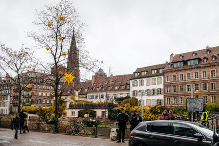 STRASBOURG, FRANCE - DEC 8, 2018: Police officers surveilling the entrance to Strasbourg Christmas Market near Rohan palace in Strasbourg during winter holiday - city center surveillanceのeditorial素材