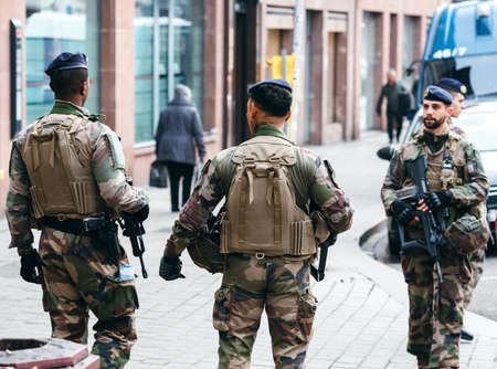 STRASBOURG, FRANCE - DEC 11, 2018: Rear view of military personnel surveilling streets of Strasbourg after the terrorist attack in the Strasbourg Christmas market areaのeditorial素材