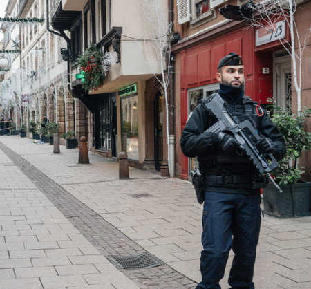 STRASBOURG, FRANCE - DEC 11, 2018: Police officer surveilling terrorist attack crime zone on Rue Des...