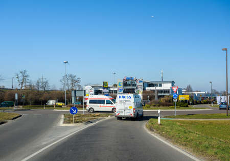 Germany - Feb 25, 2018: Cars, roundabout and Scheck-In Center Edeka shopping center in Germany on a bright winter dayのeditorial素材