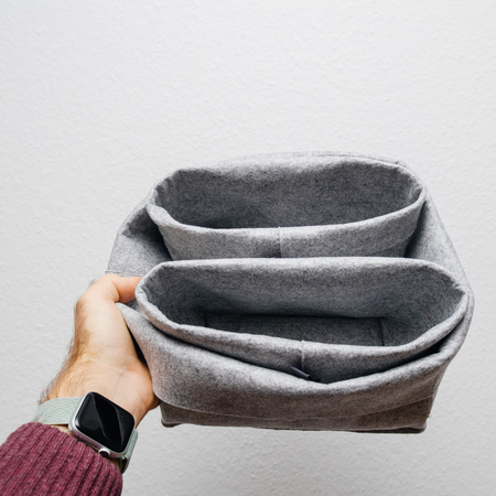 Man hand holding against white background textile bowl made from recycled materialsの写真素材