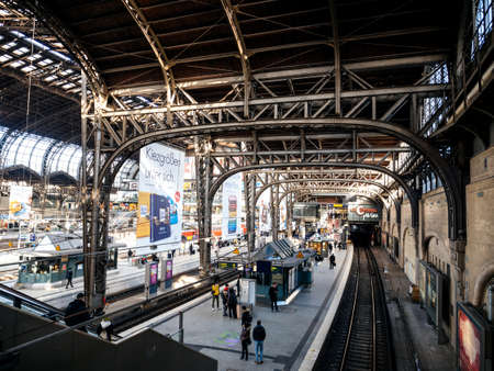 HAMBURG, GERMANY - MAR 20, 2018: Hamburg Hauptbahnhof wide interior elevate view of trains and people travelingのeditorial素材