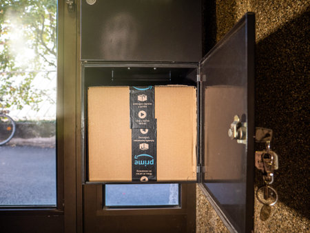 PARIS, FRANCE - OCT 26, 2018: Large mailbox with Amazon Prime Cardboard parcel - e-shopping...