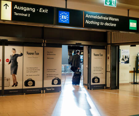 HAMBURG, GERMANY - MAR 20, 2018: Businessman exiting airport terminal through nothing to declare gateのeditorial素材