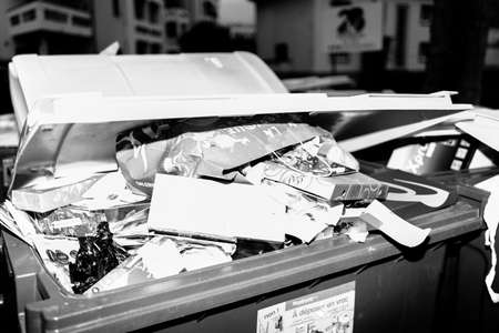 Paris, France - Jan 1, 2019: French street in Paris with dumpsters full with paper cardboard boxes after new year holidaysのeditorial素材