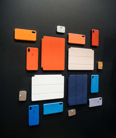 PARIS, FRANCE - OCT 25, 2018: Apple Computers protection case for iPad Pro, Apple iWatch, iPhone, MacBook pro on the wallのeditorial素材