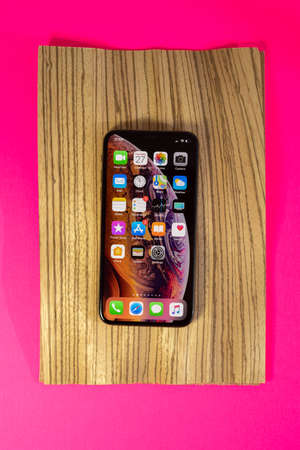 PARIS, FRANCE - SEP 27, 2018: Apple Computers iPhone Xs and Xs Max as hero object on bright glamorous modern neon pop fuchsia background - smartphone telephone with OLED displayのeditorial素材