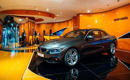 HAMBURG, GERMANY - MAR 20, 2018: Luxury BMW coupe limousine presented at the SIXT rent-a-car stand in Hamburg international Airport with orange colored wallsのeditorial素材