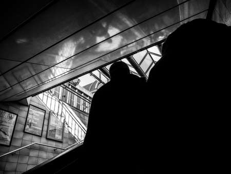 HAMBURG, GERMANY - MAR 20, 2018: Rear view of pedestrians exiting Hamburg metro station - black and whiteのeditorial素材