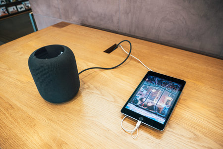 Paris, France - Dec 16, 2018: Apple Computers iPad tablet next to new Apple HomePod wireless speaker...