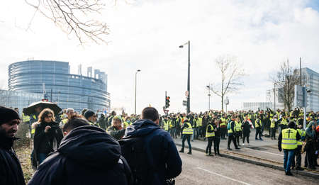STRASBOURG, FRANCE - FEB 02, 2018: People demonstrating walking during protest of Gilets Jaunes Yellow Vest manifestation on the 12 Saturday of anti-government demonstrationsのeditorial素材