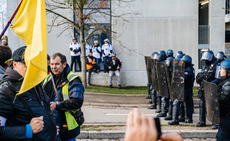 STRASBOURG, FRANCE - FEB 02, 2018: Side view of armed police officers Brigade Anti-Criminalite de la Police Nationale protest of Gilets Jaunes Yellow Vest manifestation of anti-government demonstrationsのeditorial素材