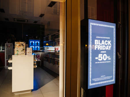 STRASBOURG, FRANCE - CIRCA 2019: Digital display at night Black Friday minus 50 percent sign on the showcase glass of a store in central shopping street during Black Friday salesのeditorial素材